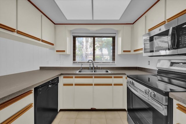 kitchen featuring light tile patterned floors, sink, white cabinets, and appliances with stainless steel finishes