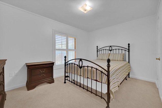 bedroom featuring ornamental molding and light colored carpet