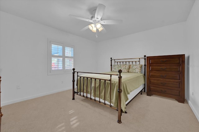 bedroom featuring ceiling fan and light carpet