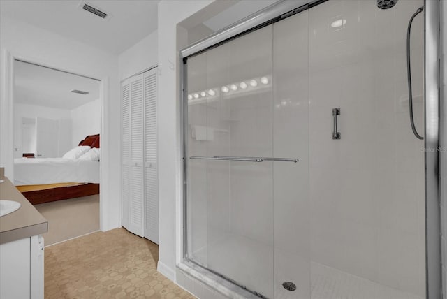 bathroom with an enclosed shower and vanity