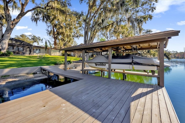 view of dock with a yard and a water view