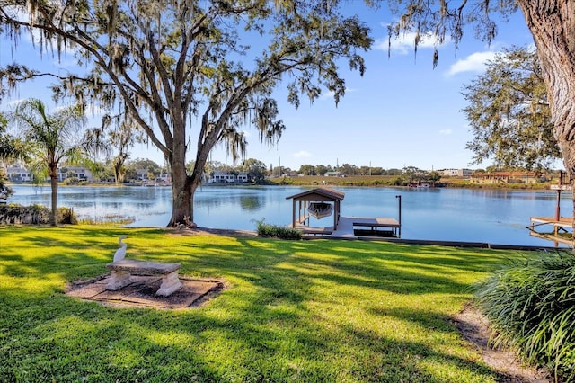 view of yard featuring a boat dock and a water view