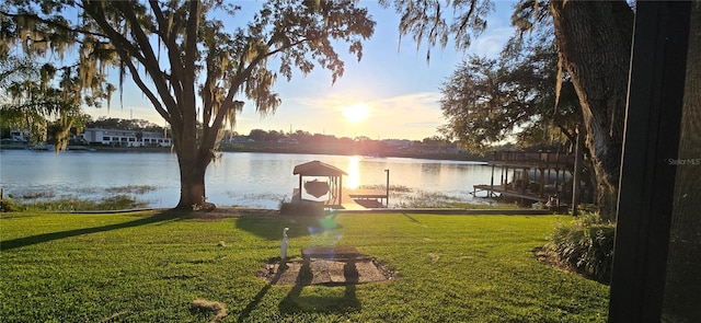 dock area featuring a yard and a water view