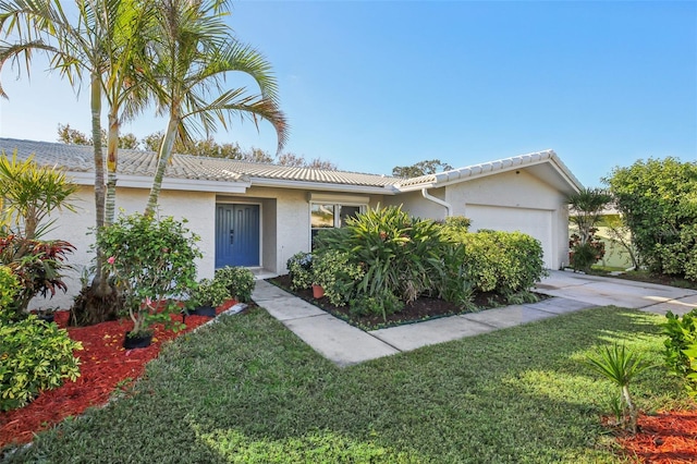 ranch-style house with a garage and a front lawn