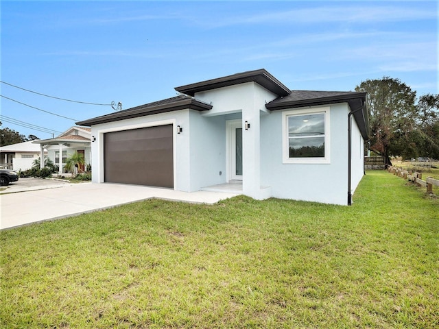 view of front of home featuring a garage and a front lawn