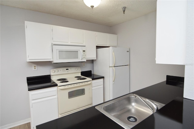 kitchen with a textured ceiling, sink, white cabinets, and white appliances