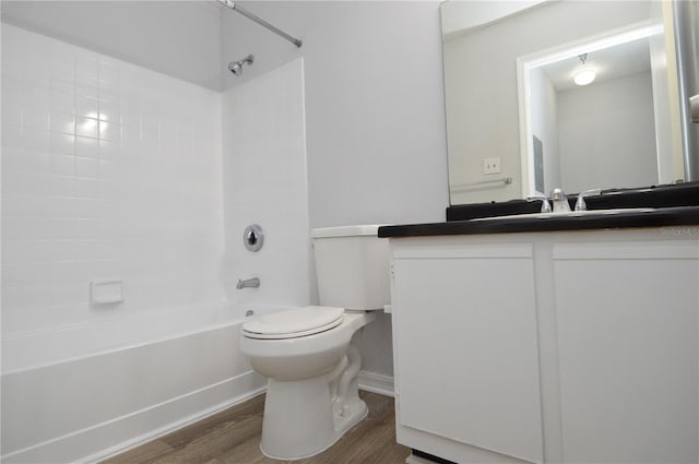 full bathroom featuring vanity, toilet, tiled shower / bath, and hardwood / wood-style flooring