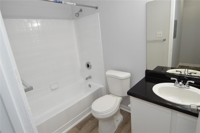 full bathroom with toilet, vanity,  shower combination, and hardwood / wood-style flooring