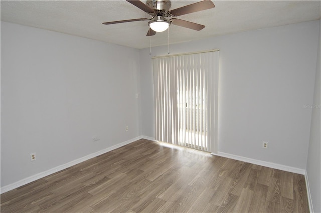 empty room featuring a textured ceiling, hardwood / wood-style flooring, and ceiling fan