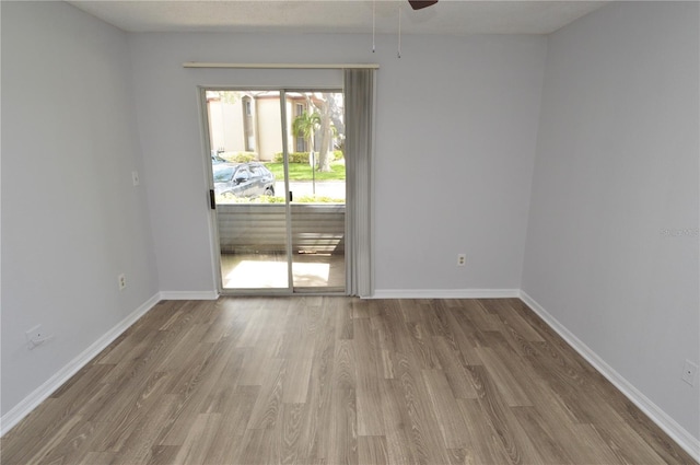 spare room with hardwood / wood-style floors and ceiling fan