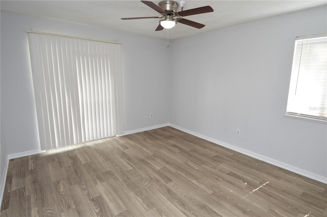 unfurnished room with light wood-type flooring and ceiling fan