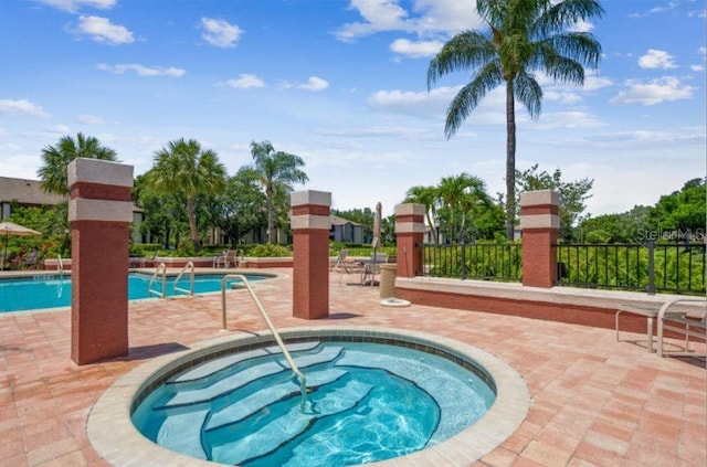 view of pool featuring a patio area and a hot tub