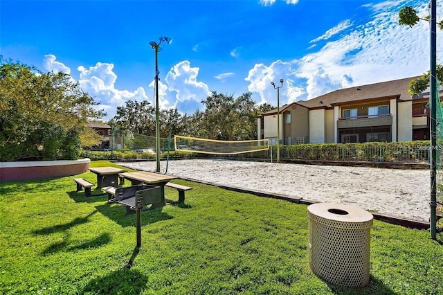 view of home's community with a lawn and volleyball court