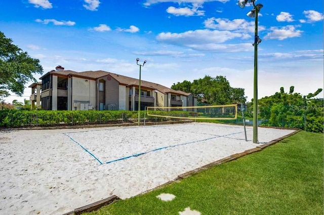 view of property's community with volleyball court and a yard