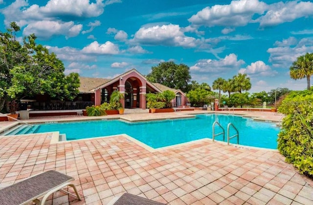 view of swimming pool with a patio area