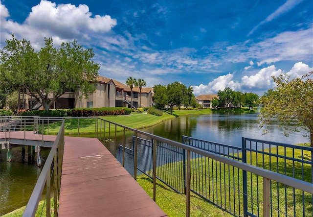 dock area featuring a lawn and a water view