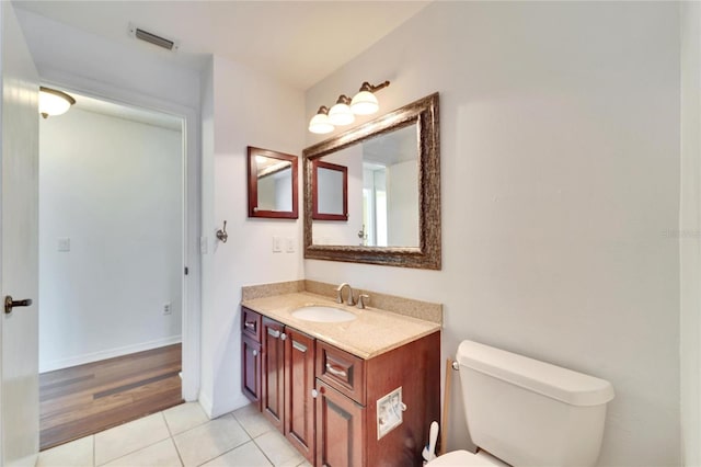 bathroom with vanity, tile patterned floors, and toilet