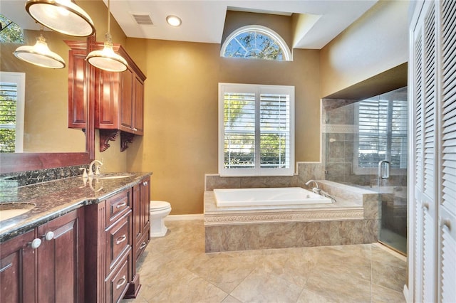 full bathroom featuring vanity, separate shower and tub, a healthy amount of sunlight, and toilet