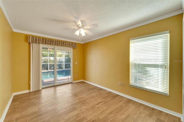 empty room with crown molding, ceiling fan, light hardwood / wood-style floors, and a textured ceiling