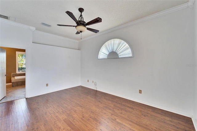 unfurnished room with ornamental molding, dark wood-type flooring, a textured ceiling, and ceiling fan