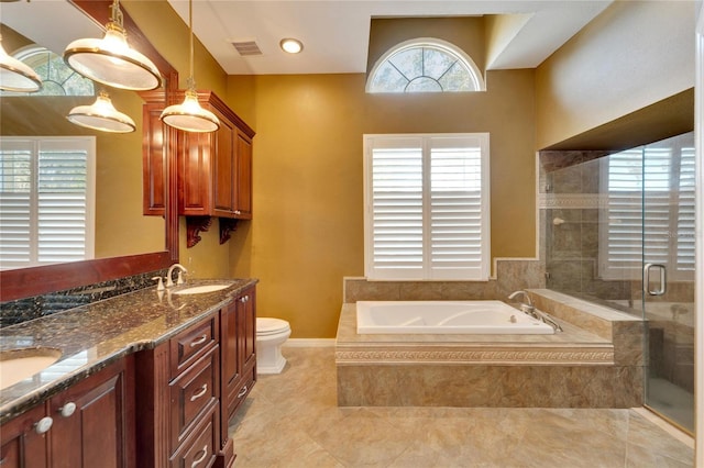 full bathroom featuring vanity, separate shower and tub, and toilet