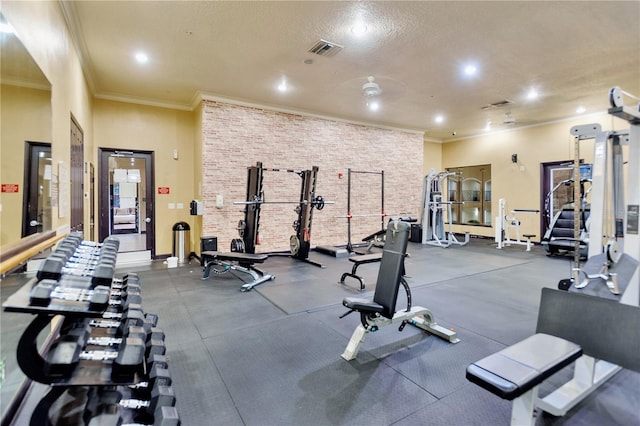 exercise room featuring ornamental molding and a textured ceiling