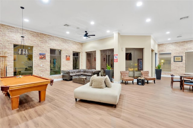 game room featuring ceiling fan, pool table, light hardwood / wood-style flooring, brick wall, and ornamental molding