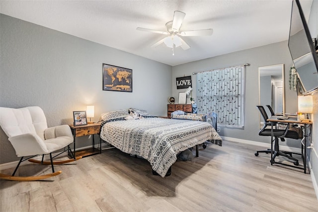 bedroom with ceiling fan and light wood-type flooring