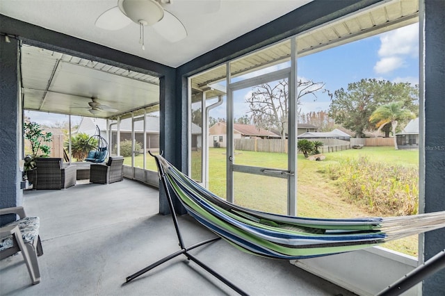 sunroom featuring ceiling fan and a healthy amount of sunlight