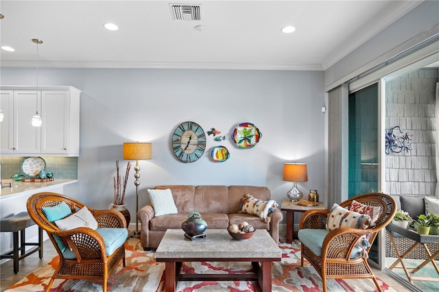 living room featuring light hardwood / wood-style flooring and ornamental molding