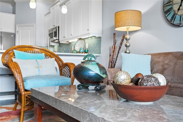 living area with ornamental molding