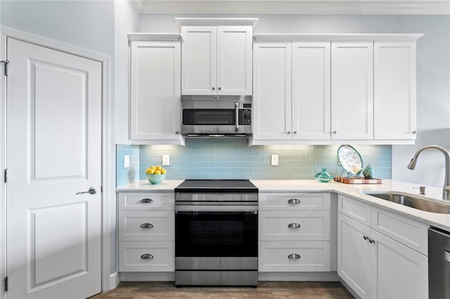 kitchen featuring white cabinetry, sink, and appliances with stainless steel finishes