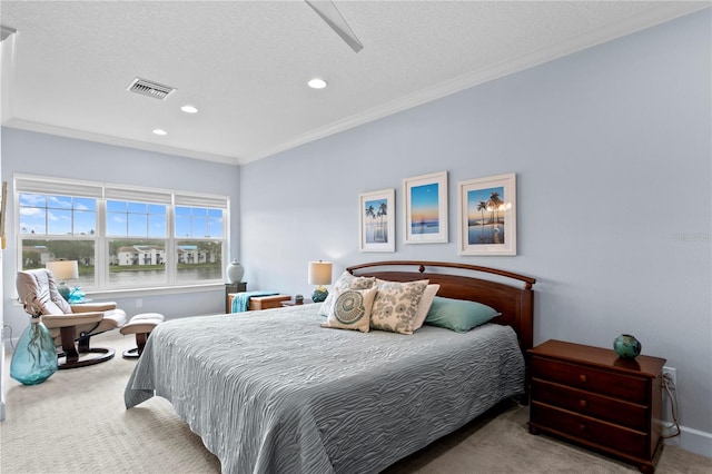 bedroom with crown molding, carpet floors, and a textured ceiling