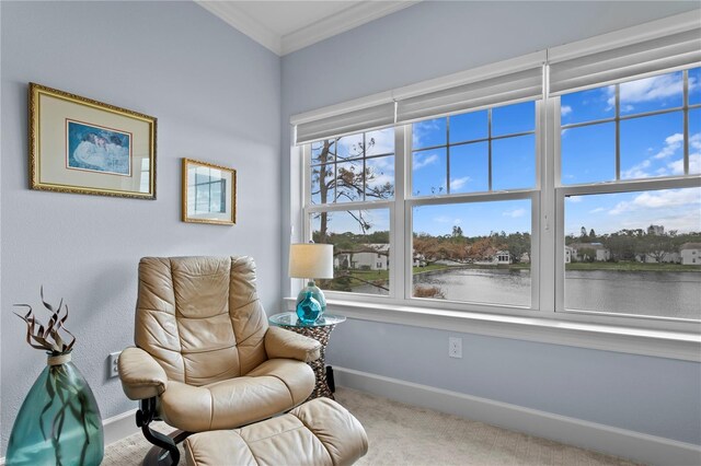 sitting room with a water view, crown molding, and light carpet