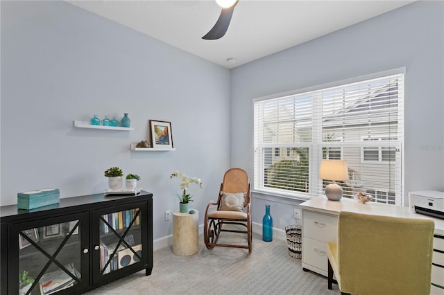 carpeted office featuring ceiling fan