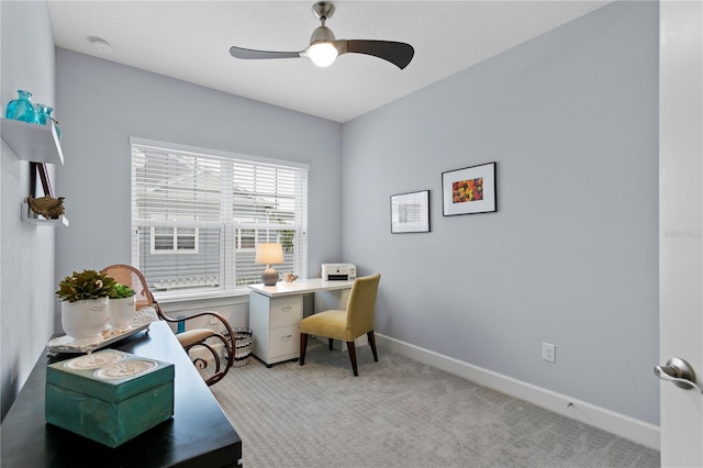 carpeted home office featuring ceiling fan