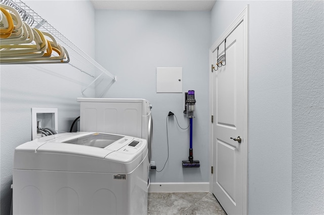 laundry area with light tile patterned floors and washer and dryer