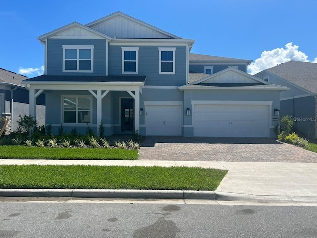 view of front facade with a porch and a garage