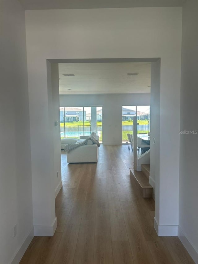 hallway with wood-type flooring