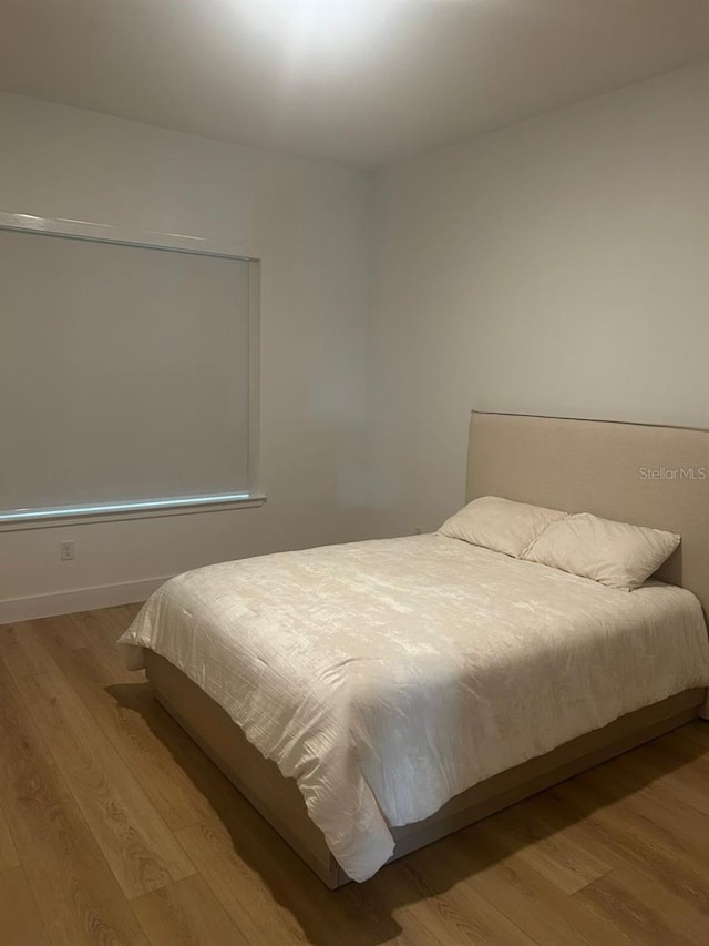 bedroom with light hardwood / wood-style floors