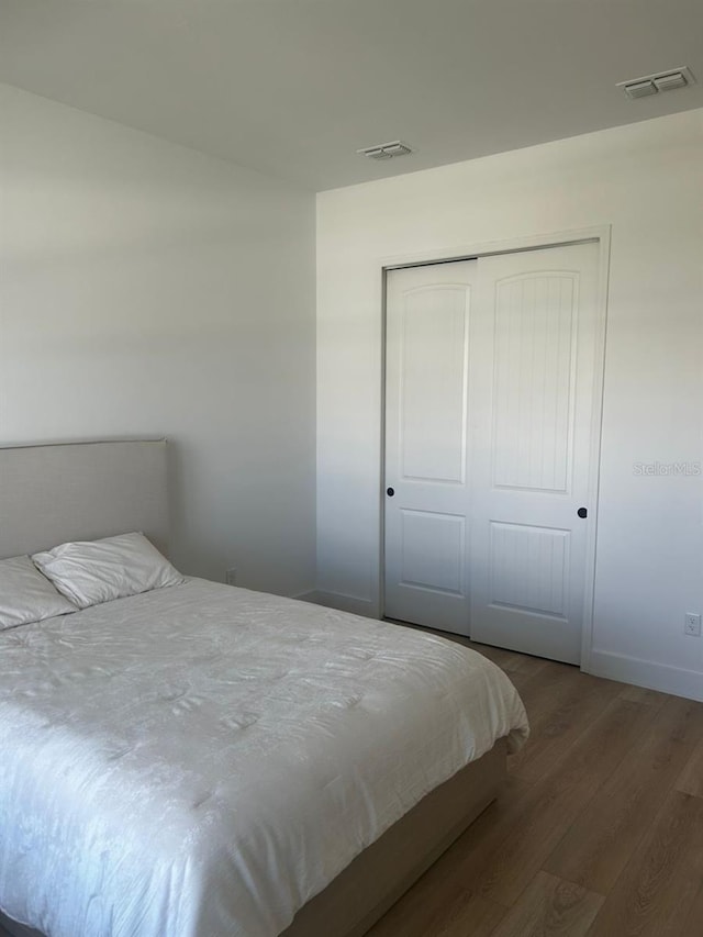 bedroom with a closet and wood-type flooring