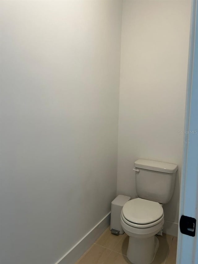 bathroom with toilet and tile patterned floors