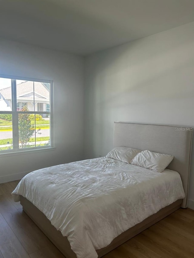 bedroom with wood finished floors