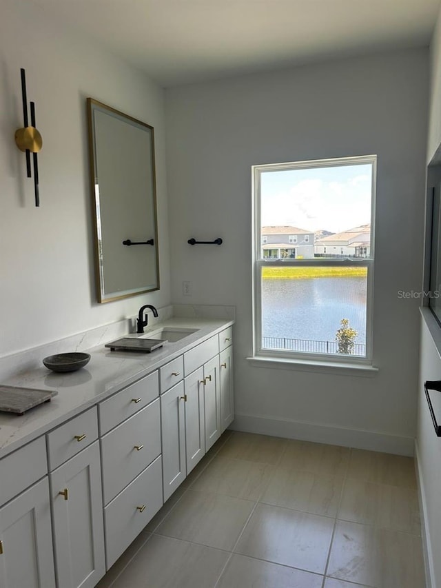 bathroom with baseboards and vanity