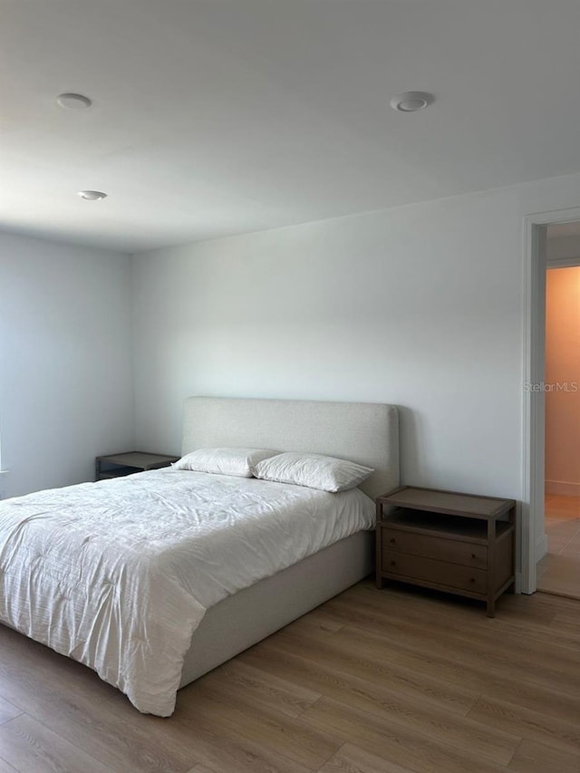 bedroom with wood finished floors