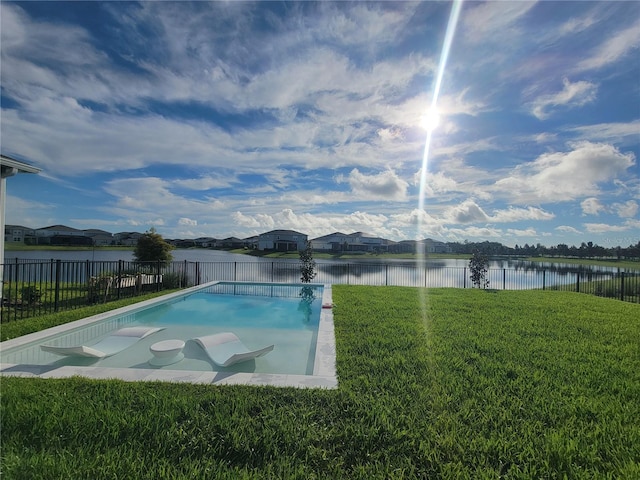 view of swimming pool featuring a fenced in pool, a fenced backyard, a lawn, and a water view