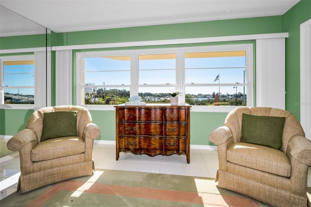 sitting room with light tile patterned floors, plenty of natural light, and baseboards