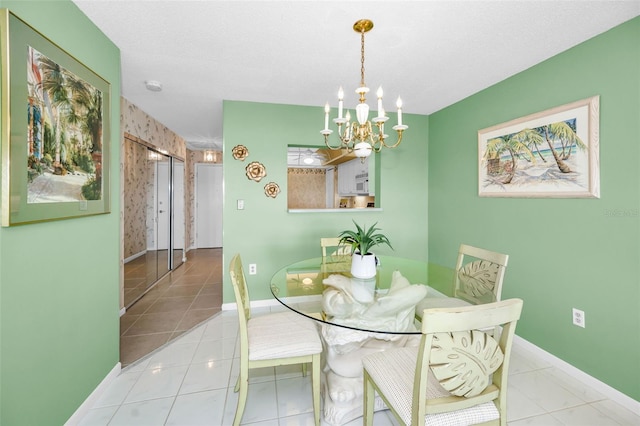 dining space with light tile patterned floors, baseboards, and an inviting chandelier