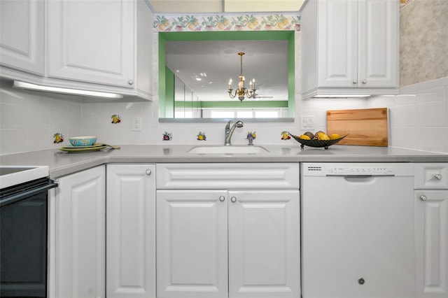 kitchen featuring white dishwasher, a sink, white cabinetry, light countertops, and pendant lighting