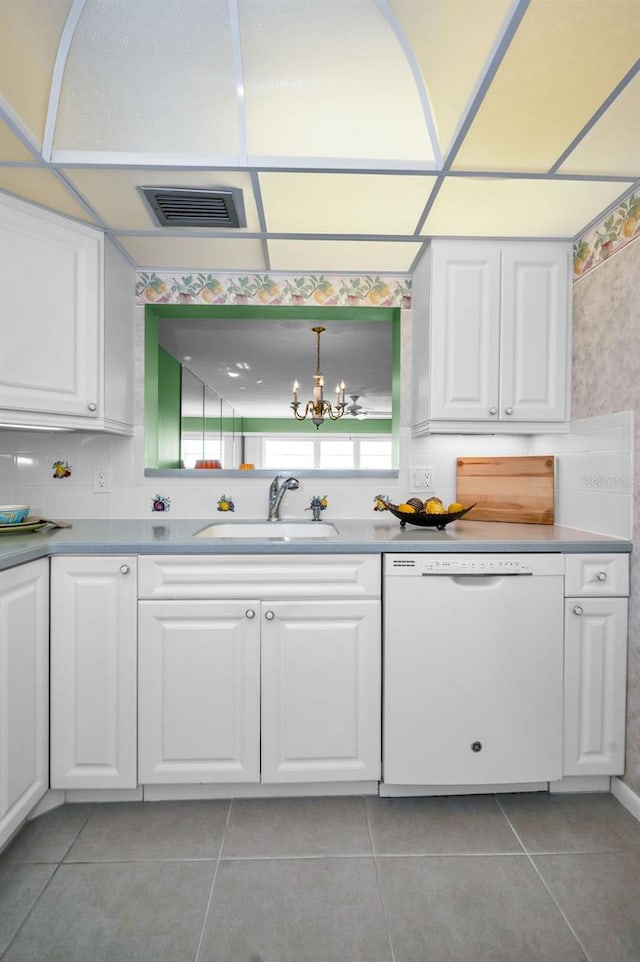 kitchen featuring dishwasher, a sink, visible vents, and white cabinets